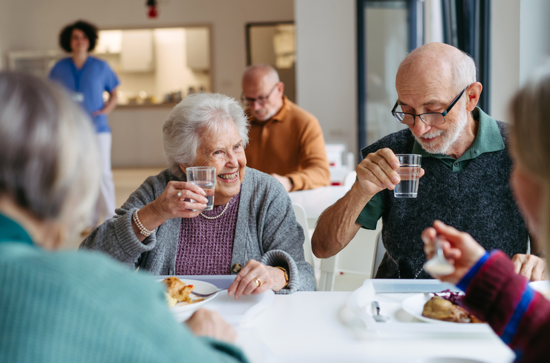 Residents sharing a meal together in the dining room at Greenleaf Court Senior Living in Whittier, CA